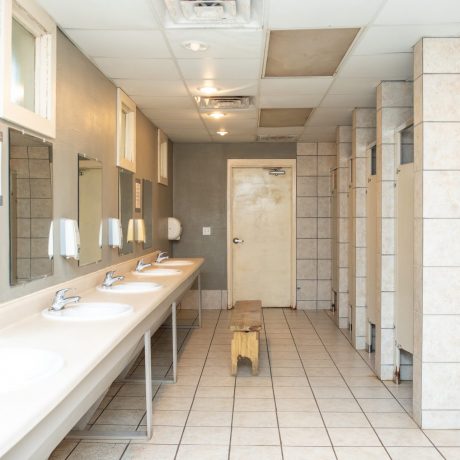 restroom interior with lavatory and stalls