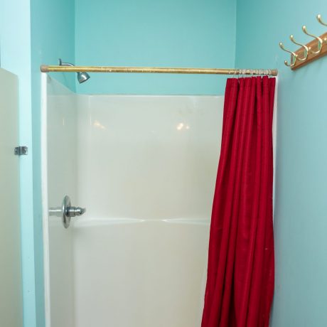 shower with red shower curtain