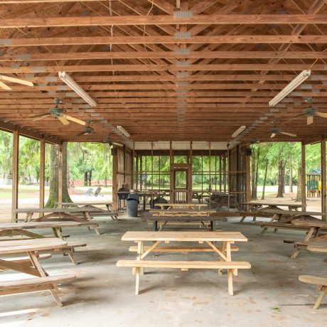 Outdoor recreational area with tables and benches