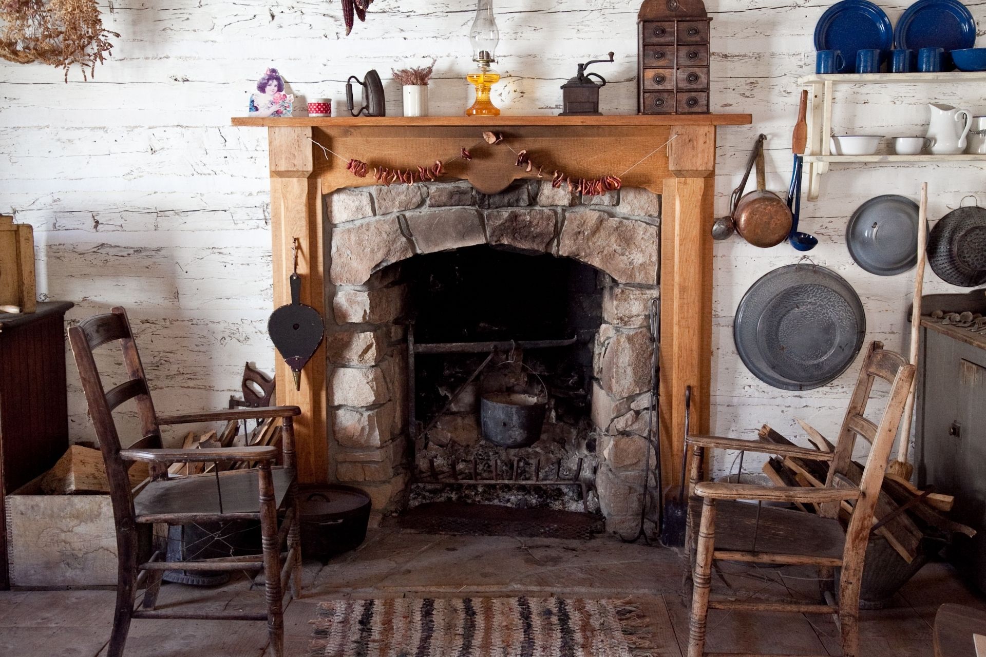 18th century fireplace and wooden chairs
